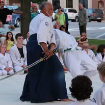 Sensei Haskins performing a sword demonstration at an outdoor event