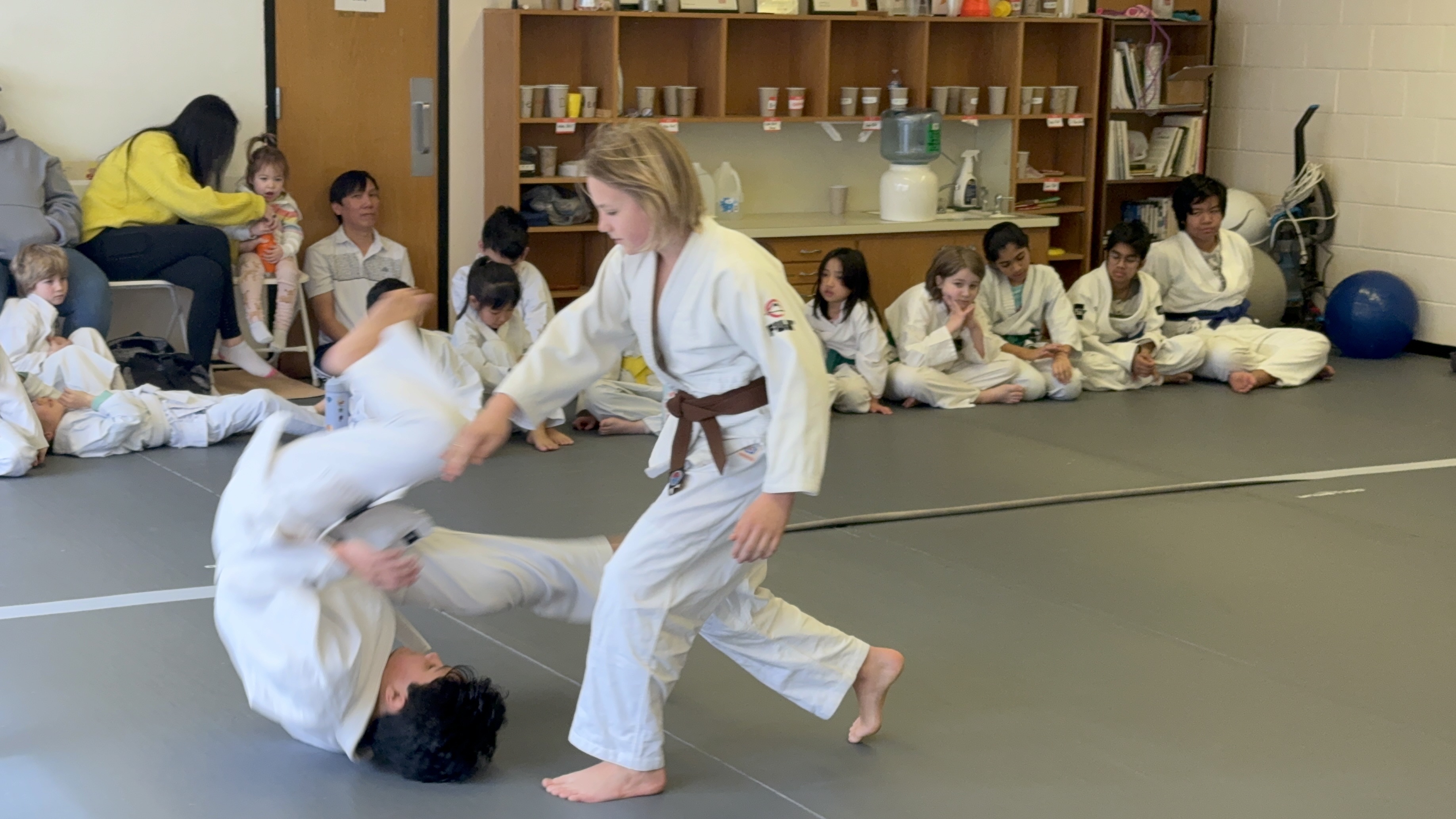 Students practicing throws in the children's class